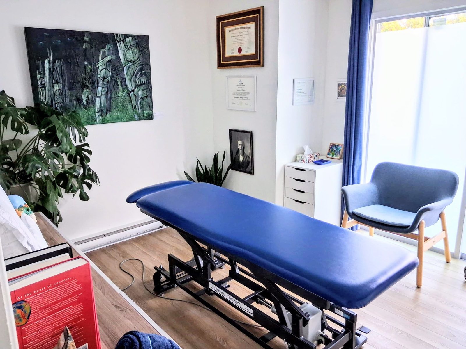 A treatment room at the clinic, with practitioner diplomas on the wall.